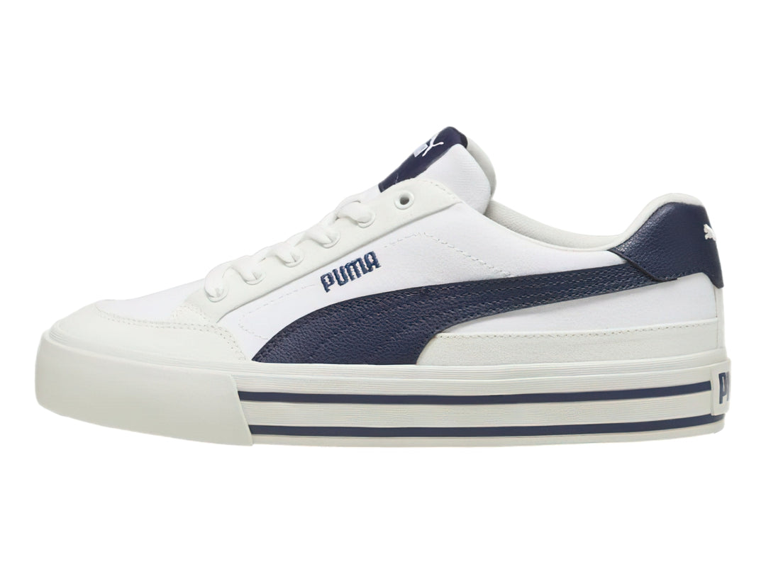Tenis PUMA Court Classic Vulc en color blanco con detalles en azul marino y suela blanca con rayas laterales azules.