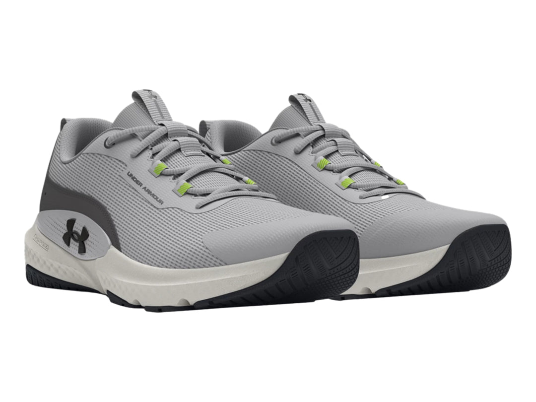 Tenis deportivos Under Armour en color gris con suela blanca y detalles en verde y negro.