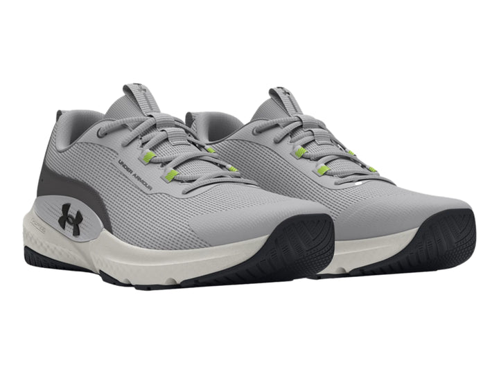Tenis deportivos Under Armour en color gris con suela blanca y detalles en verde y negro.