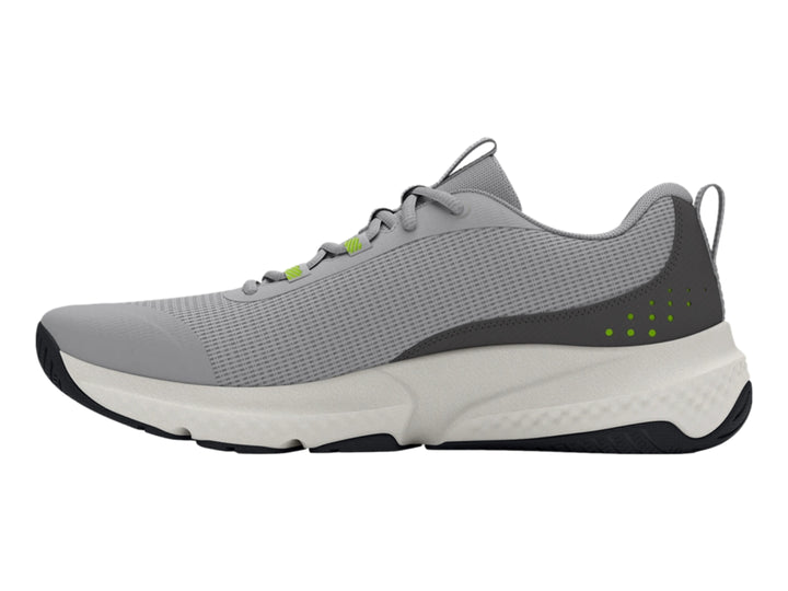Tenis deportivos Under Armour en color gris con suela blanca y detalles en verde y negro.