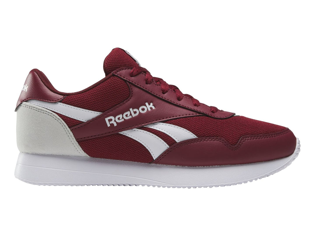 Tenis deportivos Reebok color rojo con detalles y suela blanca, vista lateral.