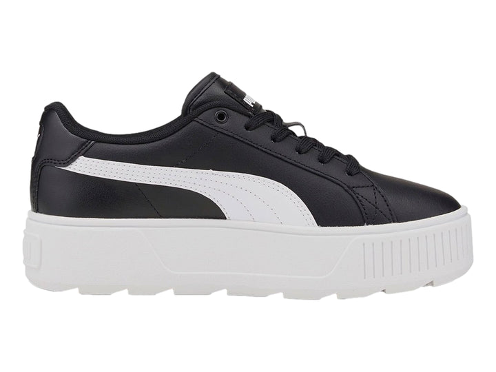 Tenis PUMA color negro con suela de plataforma blanca y franja lateral blanca.