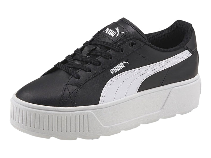 Tenis PUMA color negro con suela de plataforma blanca y franja lateral blanca.