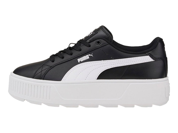 Tenis PUMA color negro con suela de plataforma blanca y franja lateral blanca.