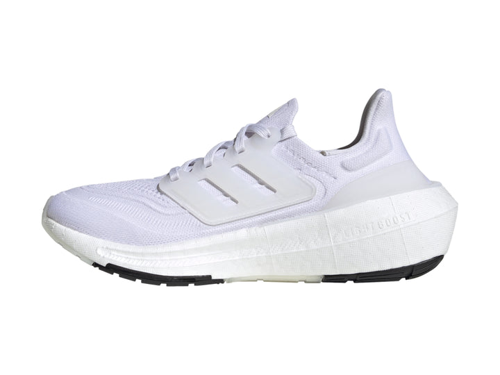 Tenis Adidas Ultraboost Light color blanco con suela negra.