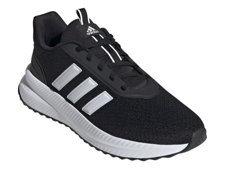 Tenis deportivos Adidas color negro con franjas y suela blanca.