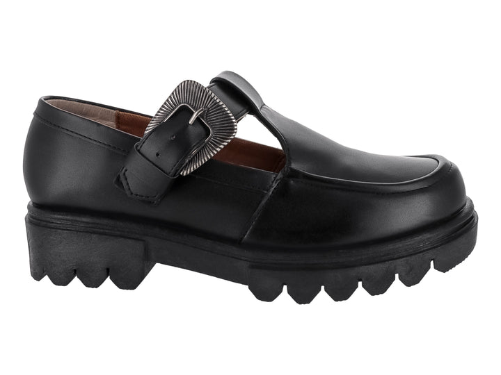 Zapato plano negro estilo Mary Jane con suela track y hebilla decorativa plateada.