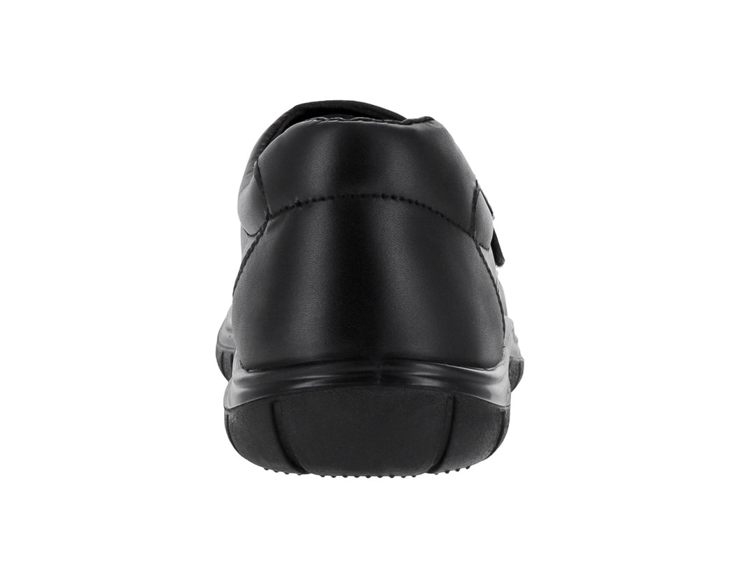 Zapato negro para niño o niña con cierre de velcro y suela cómoda sobre fondo blanco.