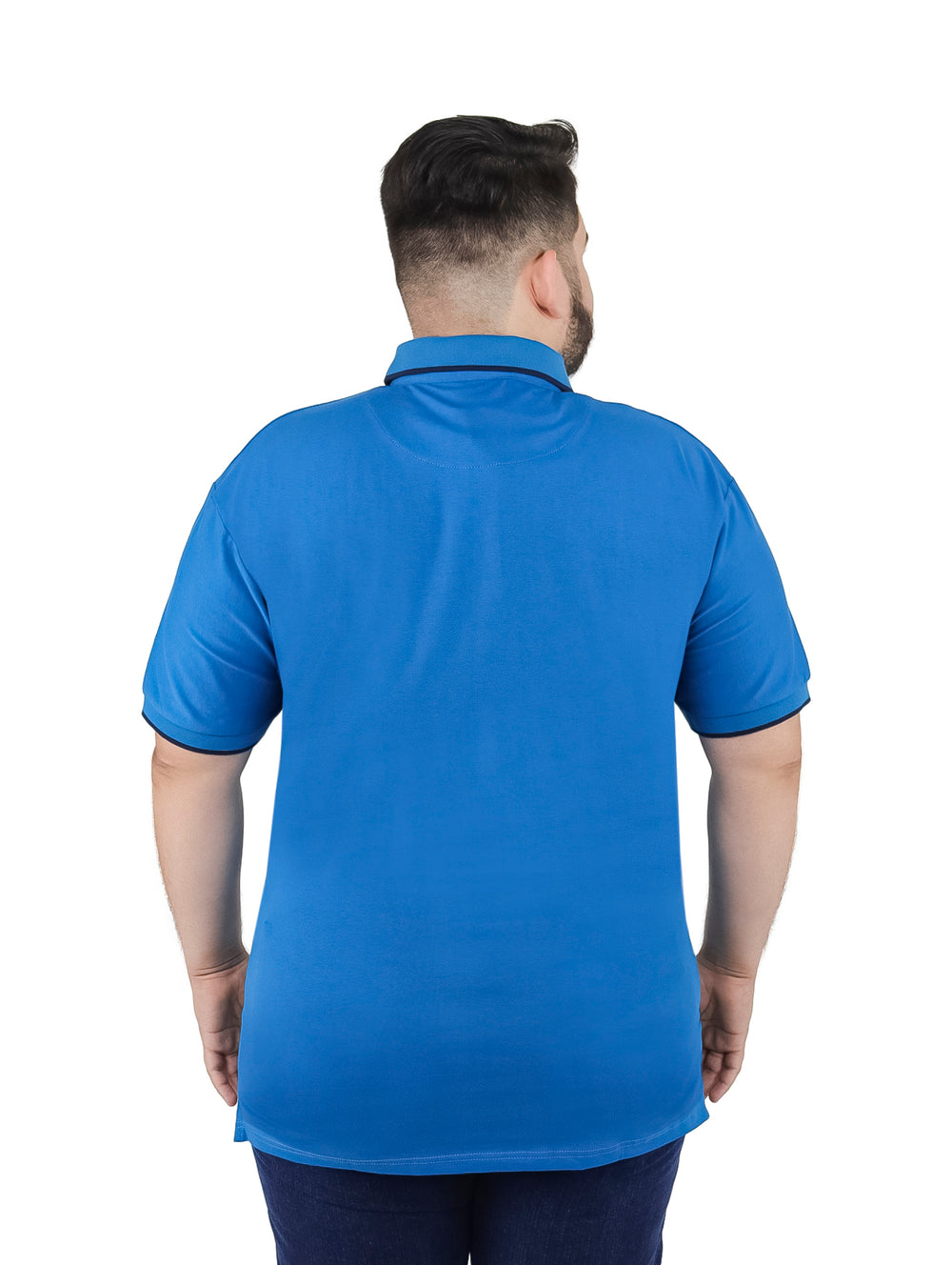 Hombre vistiendo una playera polo color azul con detalles en azul marino en el cuello y mangas.