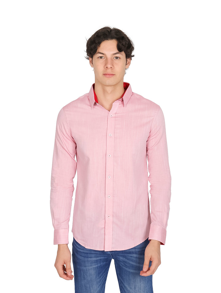 Hombre vistiendo una camisa de color rosa fresa con detalles rojos en el cuello y pantalones jeans azules.