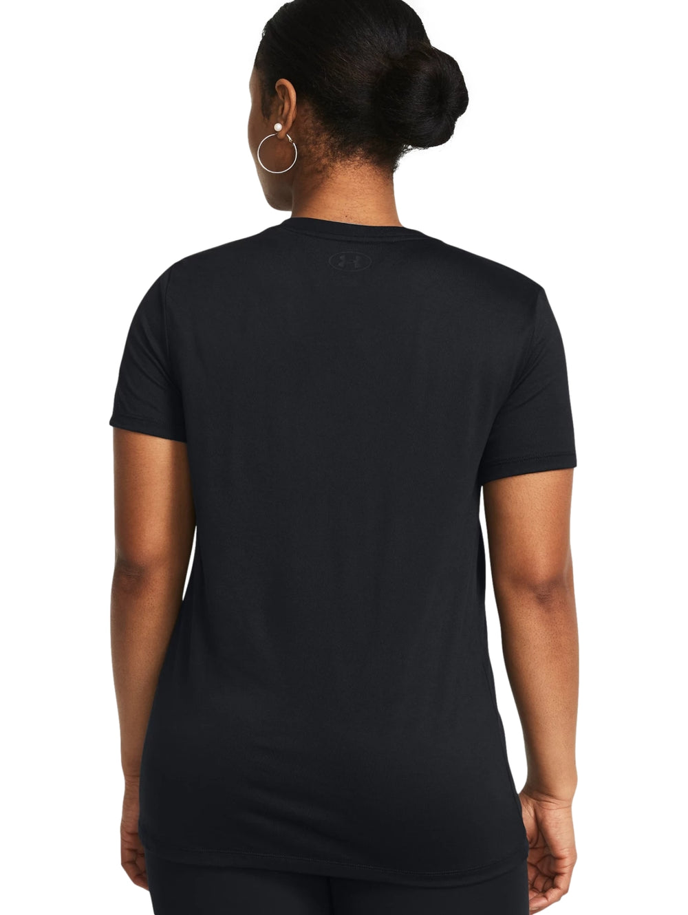Mujer vistiendo una camiseta deportiva negra de manga corta con logotipo de Under Armour en el pecho.