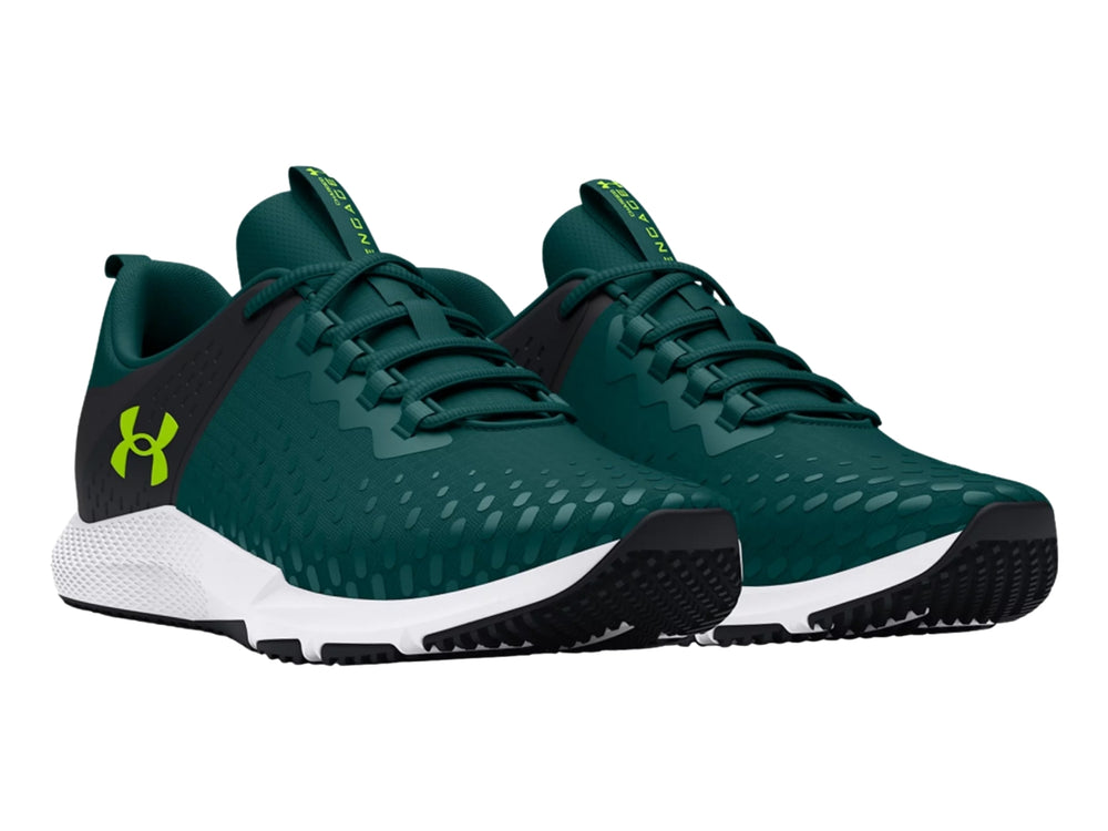 Tenis deportivos Under Armour color azul oscuro con suela blanca y detalles en verde lima.