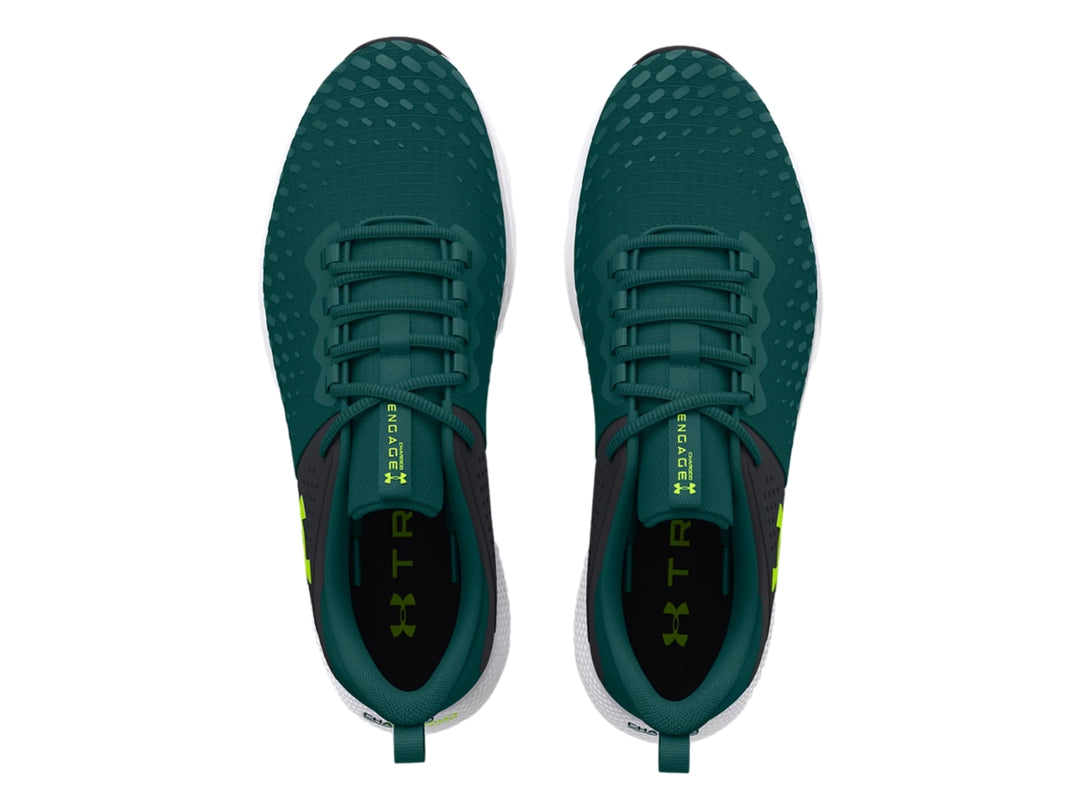Tenis deportivos Under Armour color azul oscuro con suela blanca y detalles en verde lima.