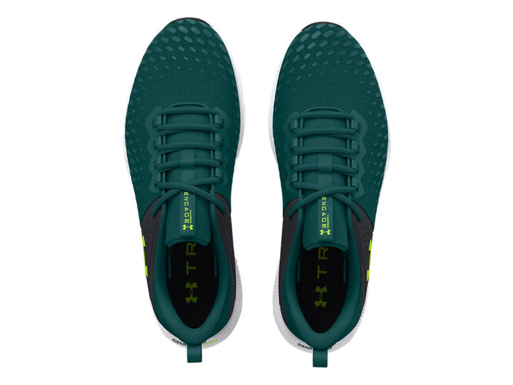 Tenis deportivos Under Armour color azul oscuro con suela blanca y detalles en verde lima.