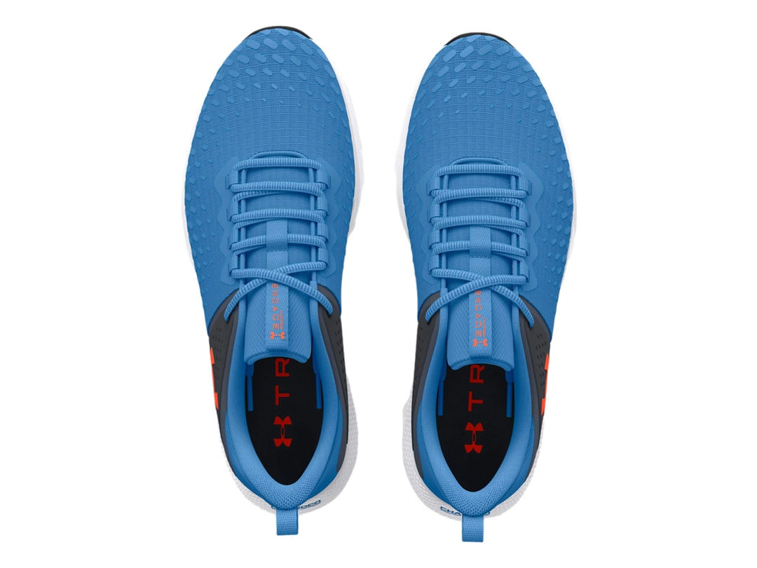 Tenis deportivos Under Armour en color azul y gris con suela blanca y detalles en negro.