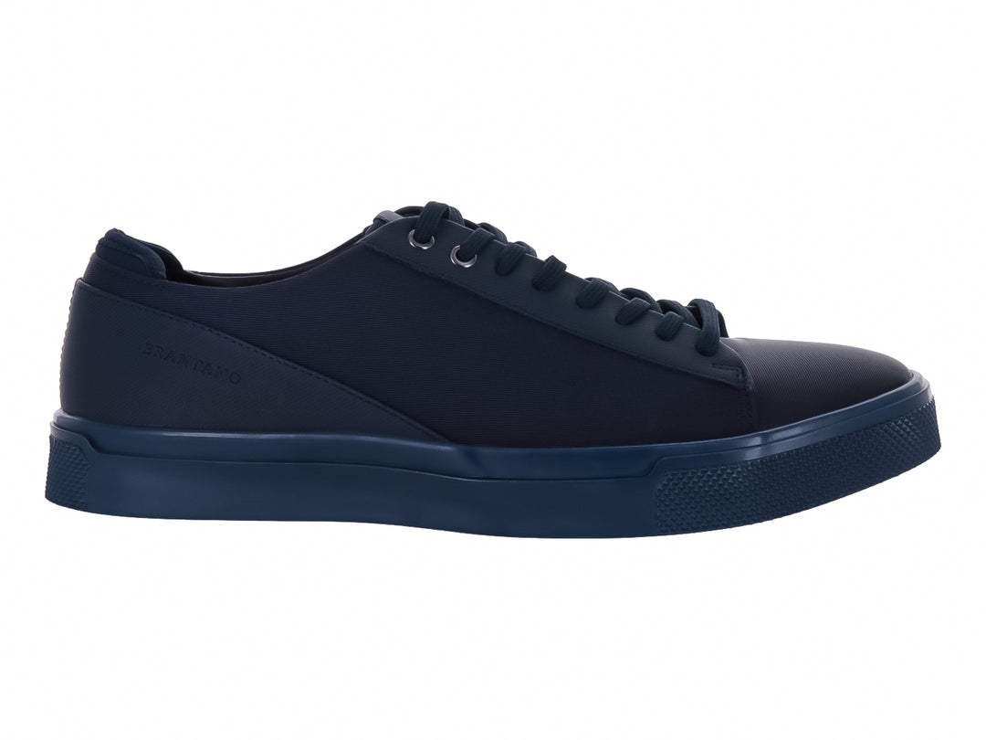Zapato casual de lona color azul marino con agujetas y suela a juego.