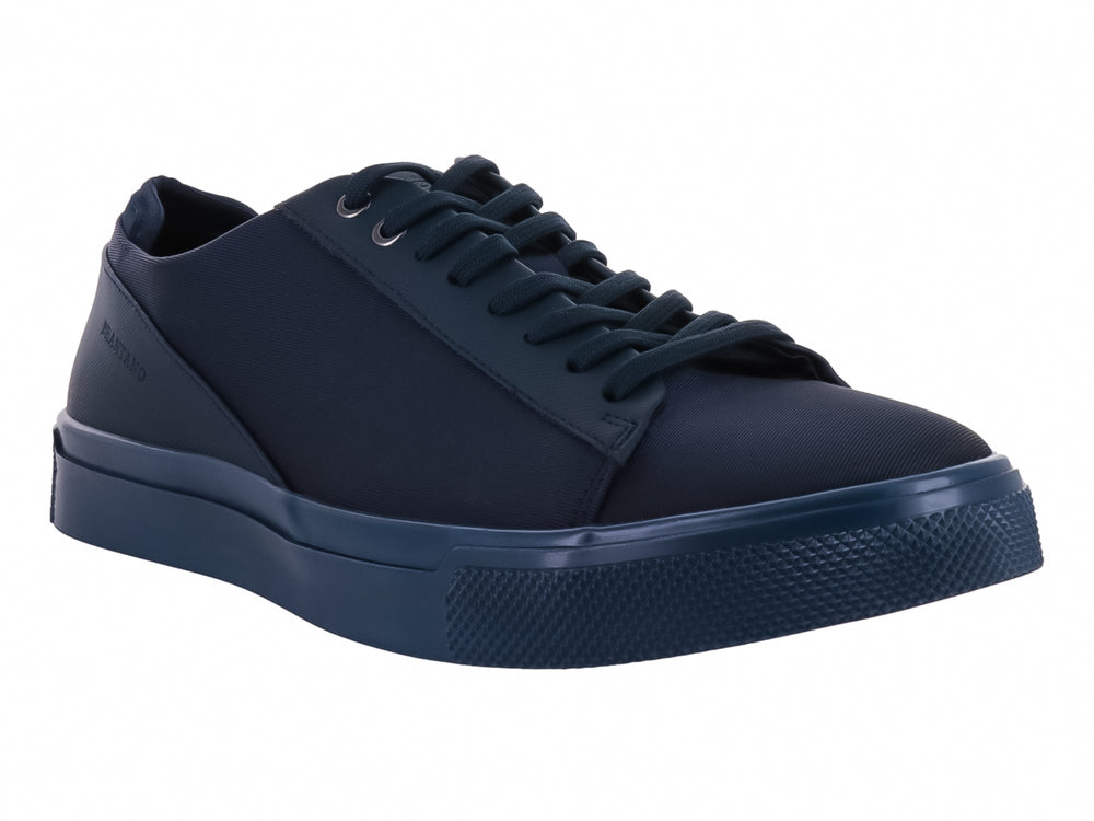 Zapato casual de lona color azul marino con agujetas y suela a juego.