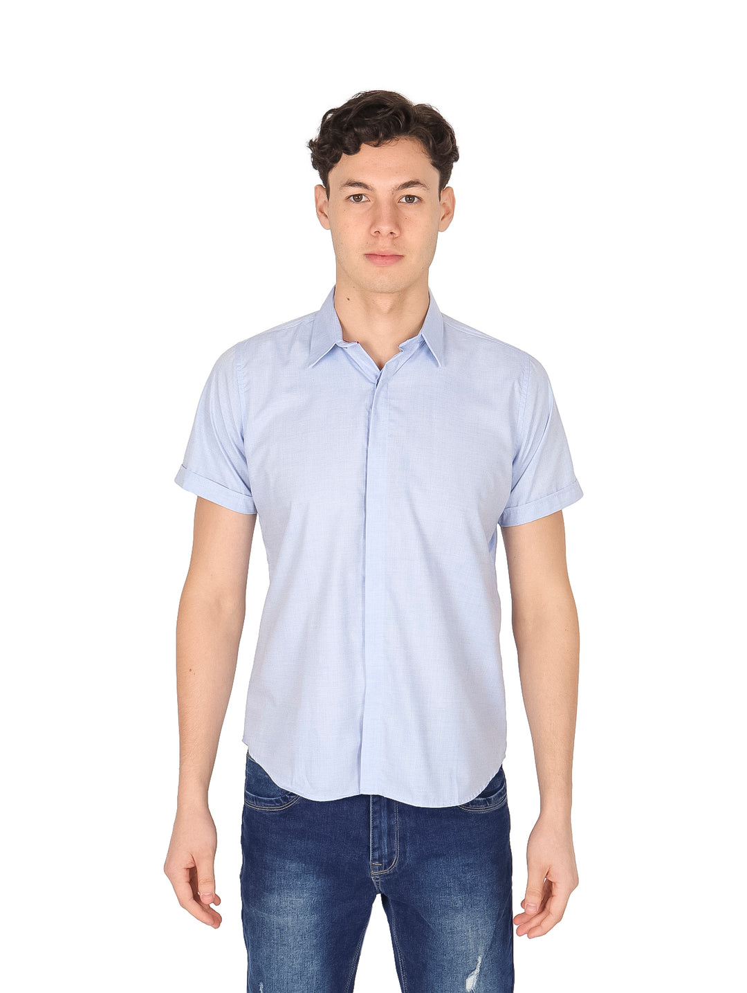 Hombre vistiendo una camisa de manga corta color azul cielo y pantalones de mezclilla.