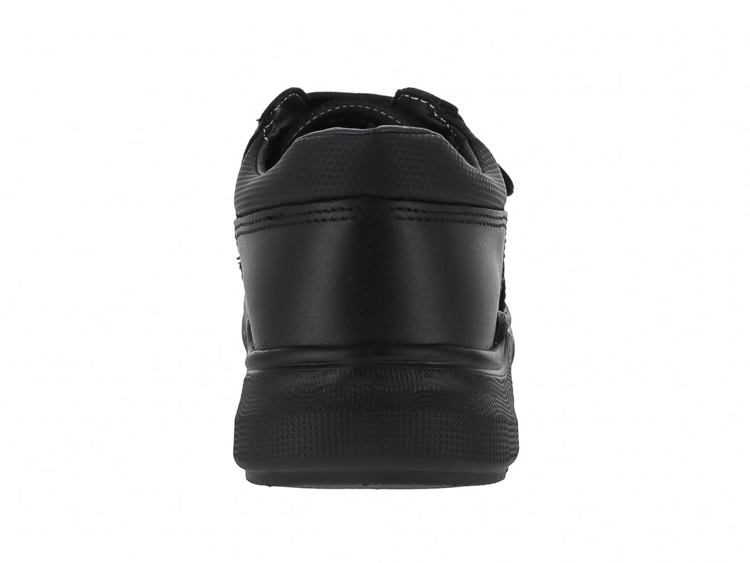 Zapato casual color negro para niño con cierre de velcro y suela robusta.
