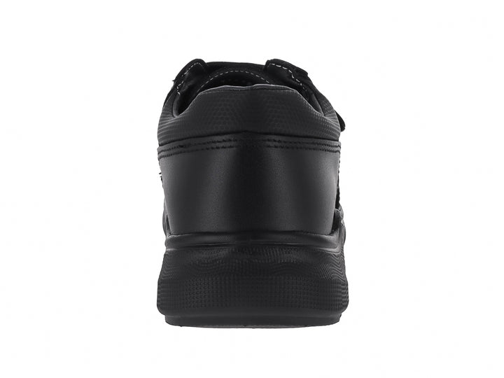 Zapato casual color negro para niño con cierre de velcro y suela robusta.