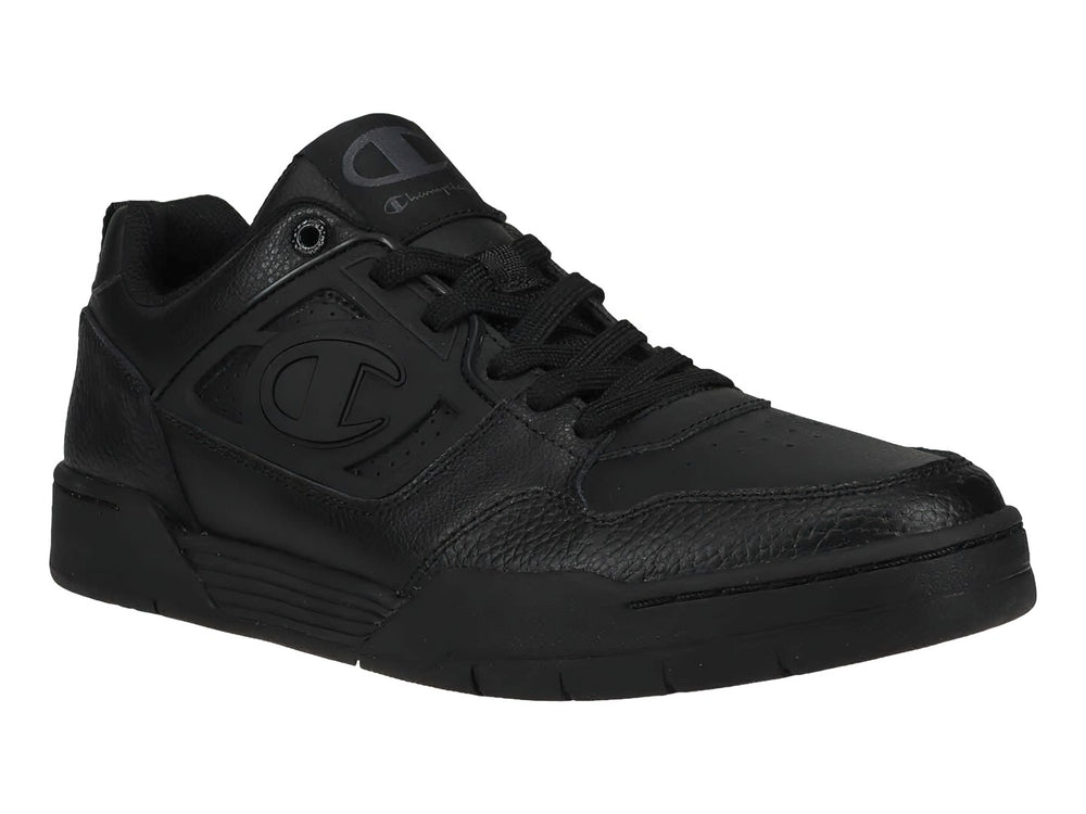 Tenis Champion color negro, corte bajo, con textura de cuero sintético y suela negra.