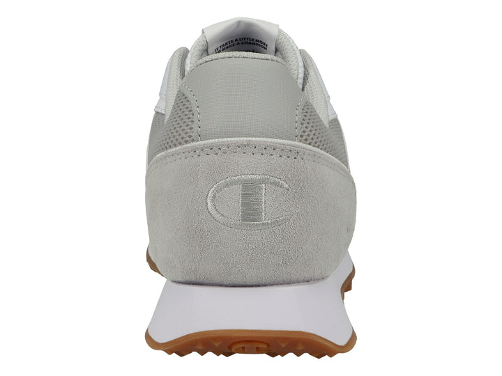 Tenis deportivos Champion en color blanco y gris con suela de goma café y detalles en malla.