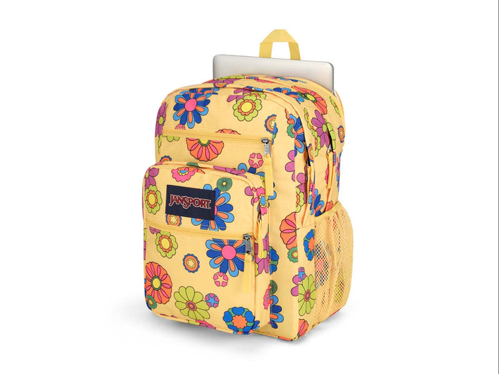 Mochila JanSport amarilla con estampado de flores multicolores en estilo retro y bolsillo frontal.