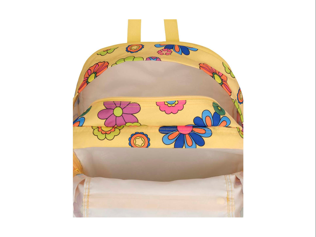 Mochila JanSport amarilla con estampado de flores multicolores en estilo retro y bolsillo frontal.