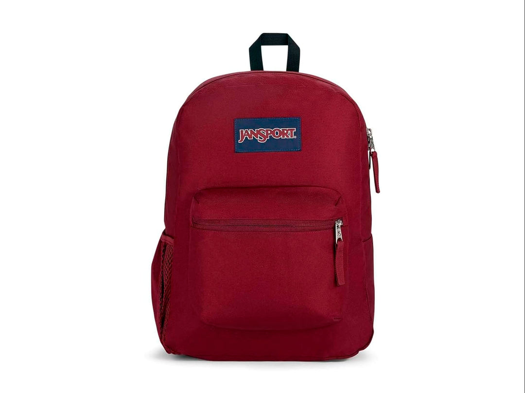 Mochila escolar JanSport color rojo russet con un bolsillo frontal y asa superior negra.
