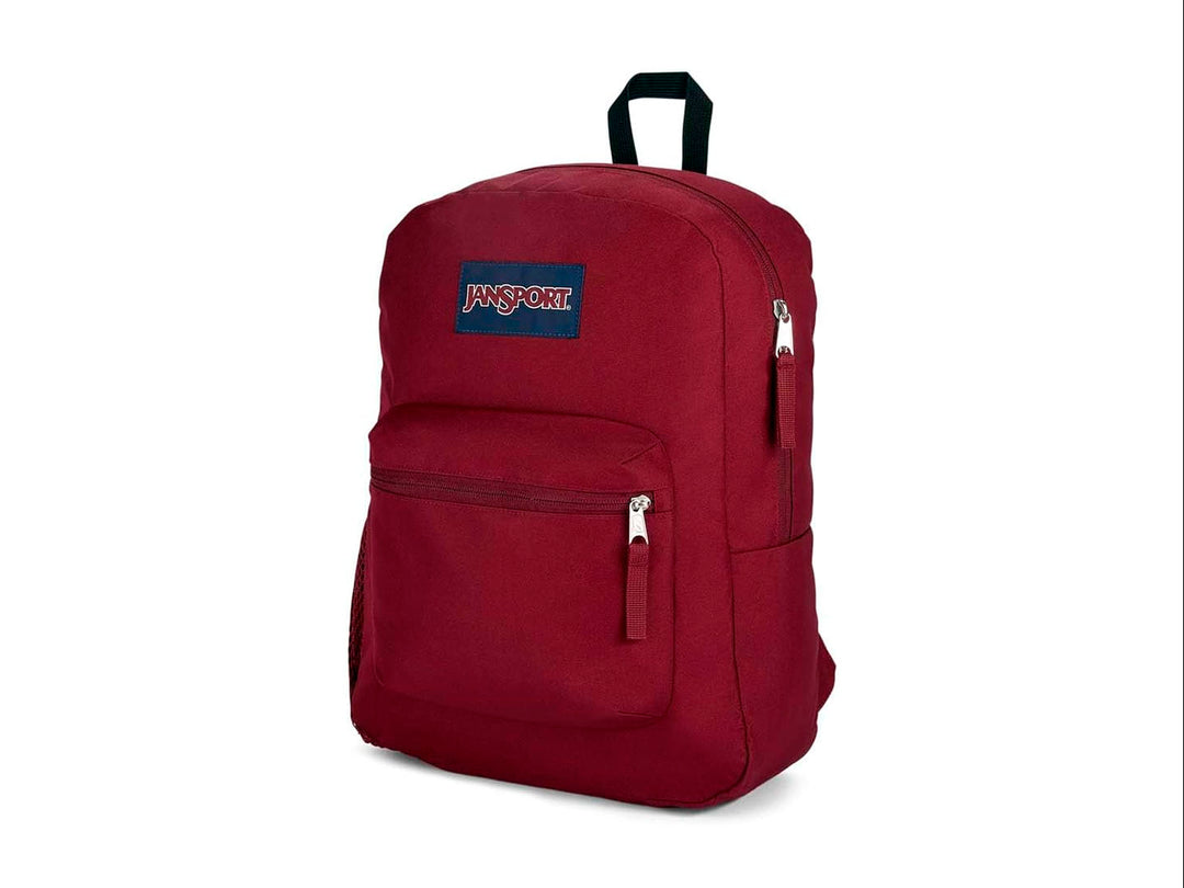 Mochila escolar JanSport color rojo russet con un bolsillo frontal y asa superior negra.