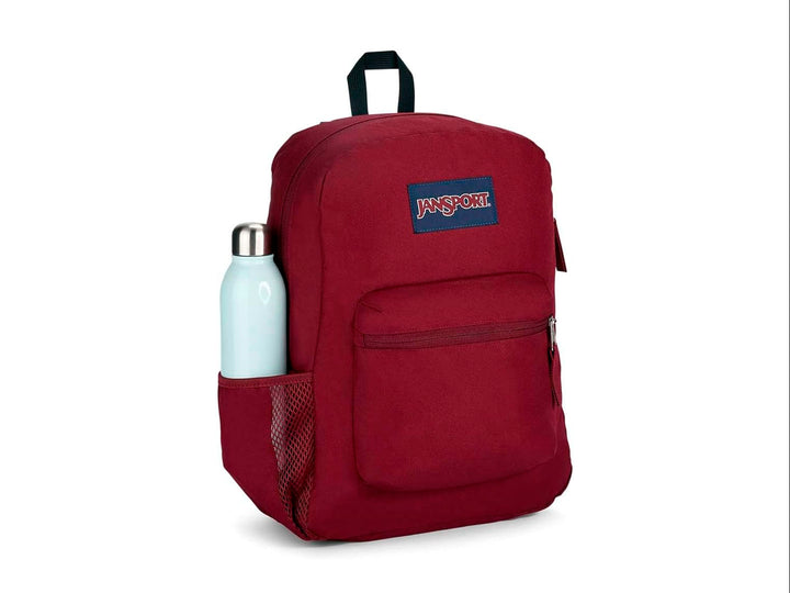 Mochila escolar JanSport color rojo russet con un bolsillo frontal y asa superior negra.