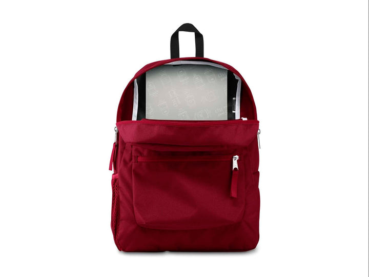 Mochila escolar JanSport color rojo russet con un bolsillo frontal y asa superior negra.