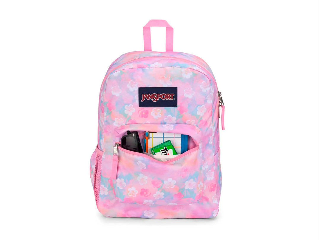 Mochila JanSport modelo Cross Town con estampado de flores en tonos rosa, azul y amarillo pastel.