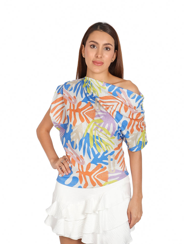 Blusa para mujer con estampado tropical multicolor y cuello asimétrico.