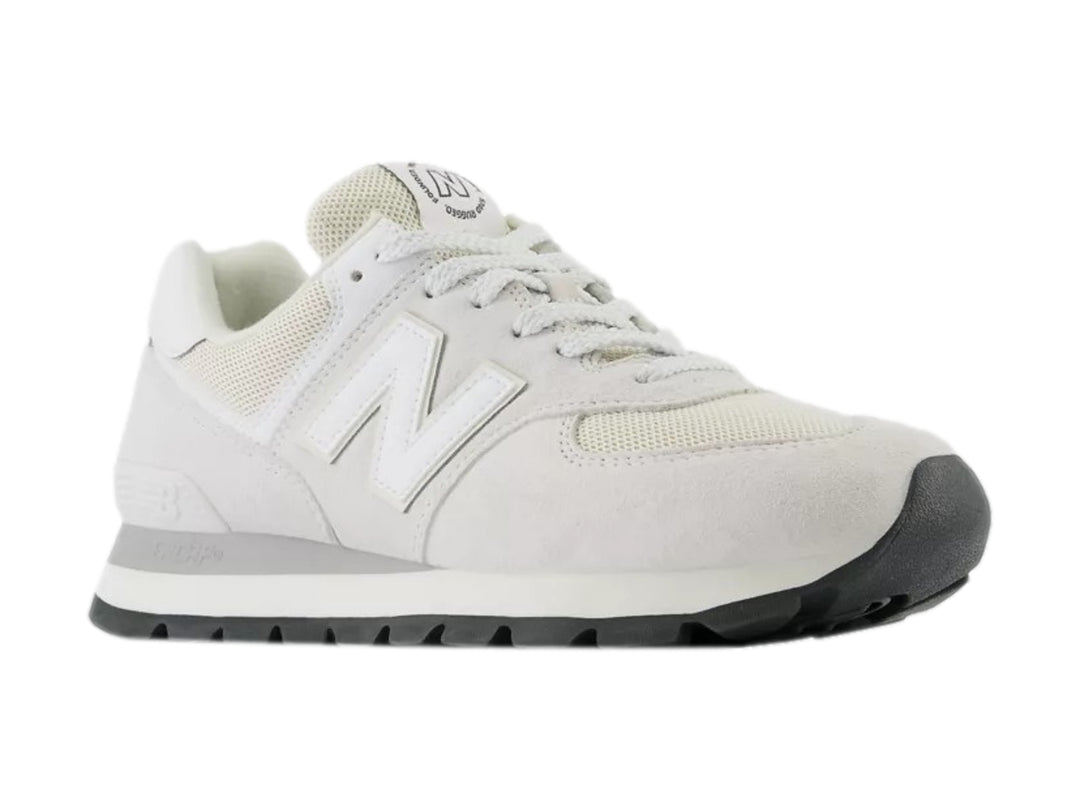 Tenis New Balance modelo 574 en color blanco y gris con detalles en gamuza y malla.