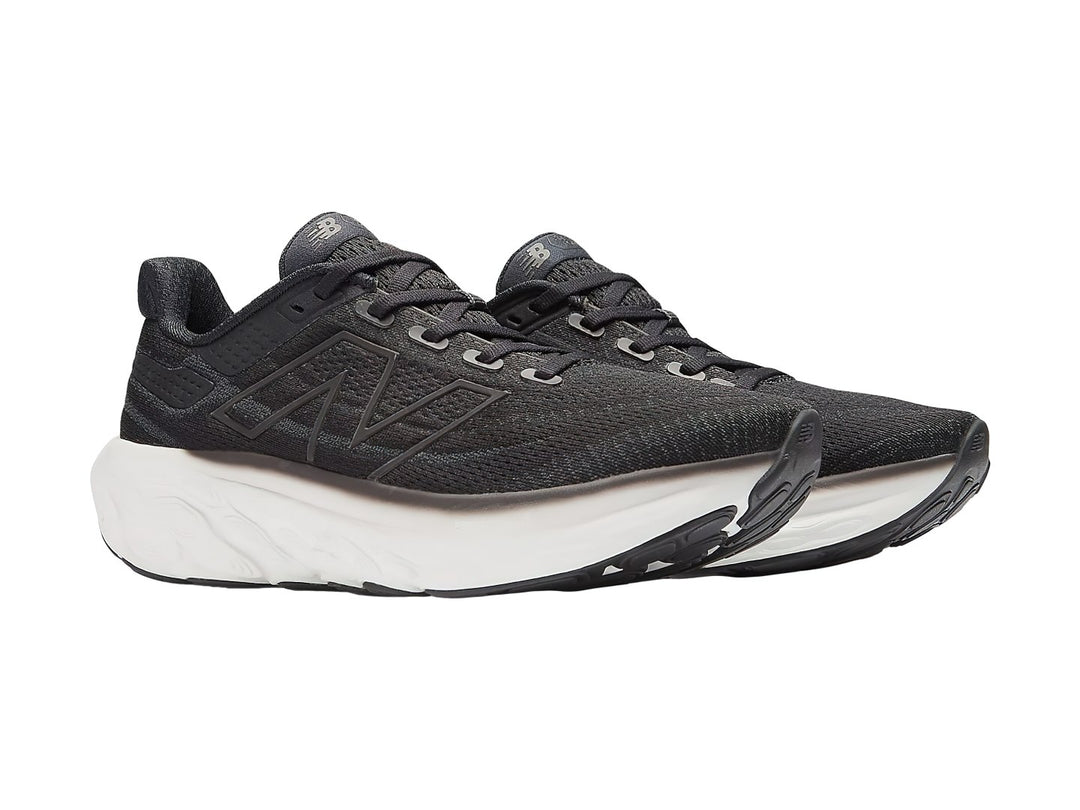 Tenis New Balance color negro con suela blanca gruesa para correr.