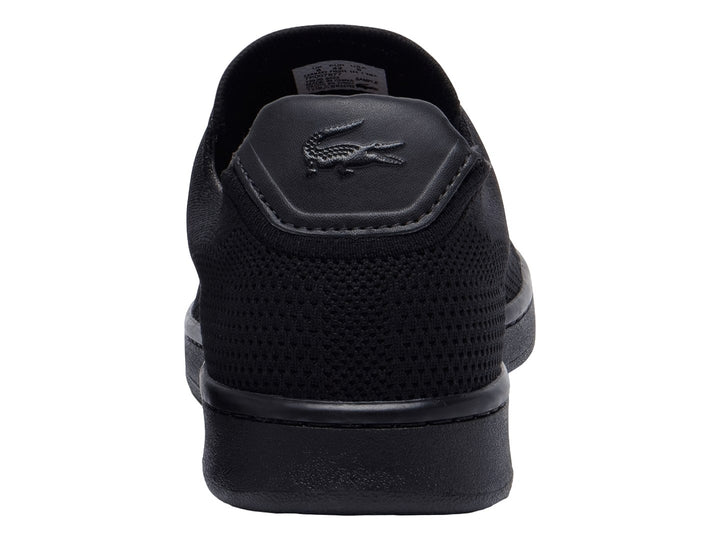 Tenis negros Lacoste de material textil con suela negra y logotipo blanco lateral.