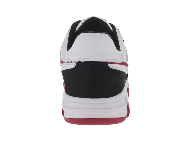 Tenis infantiles blancos con detalles en negro y suela roja, estilo deportivo.