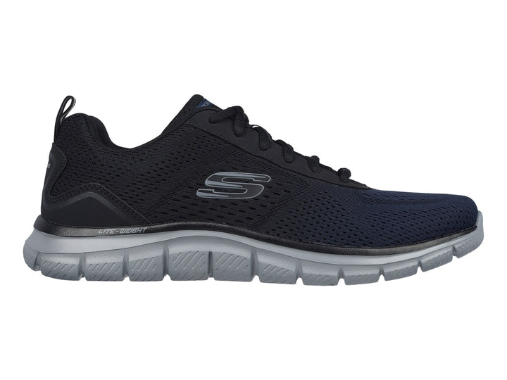 Tenis deportivos Skechers en color azul marino con suela gris y tejido de malla transpirable.