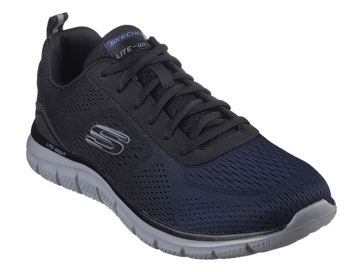 Tenis deportivos Skechers en color azul marino con suela gris y tejido de malla transpirable.