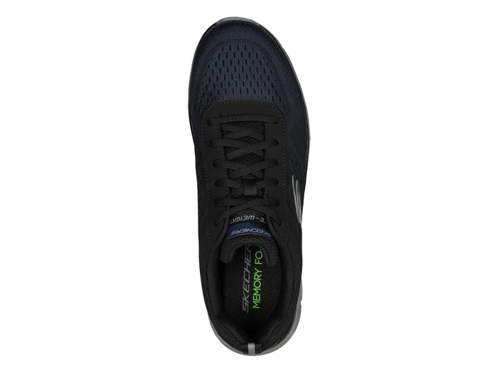 Tenis deportivos Skechers en color azul marino con suela gris y tejido de malla transpirable.