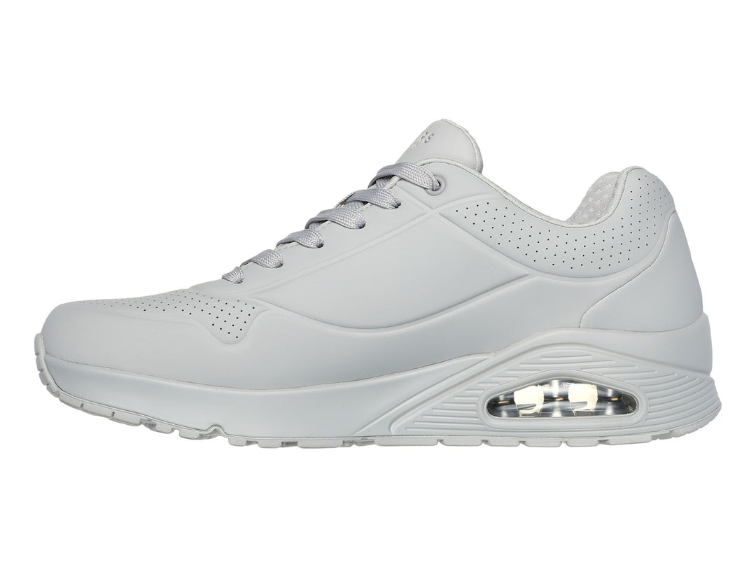 Tenis deportivos SKECHERS ONE color gris con suela amortiguada y detalles perforados.