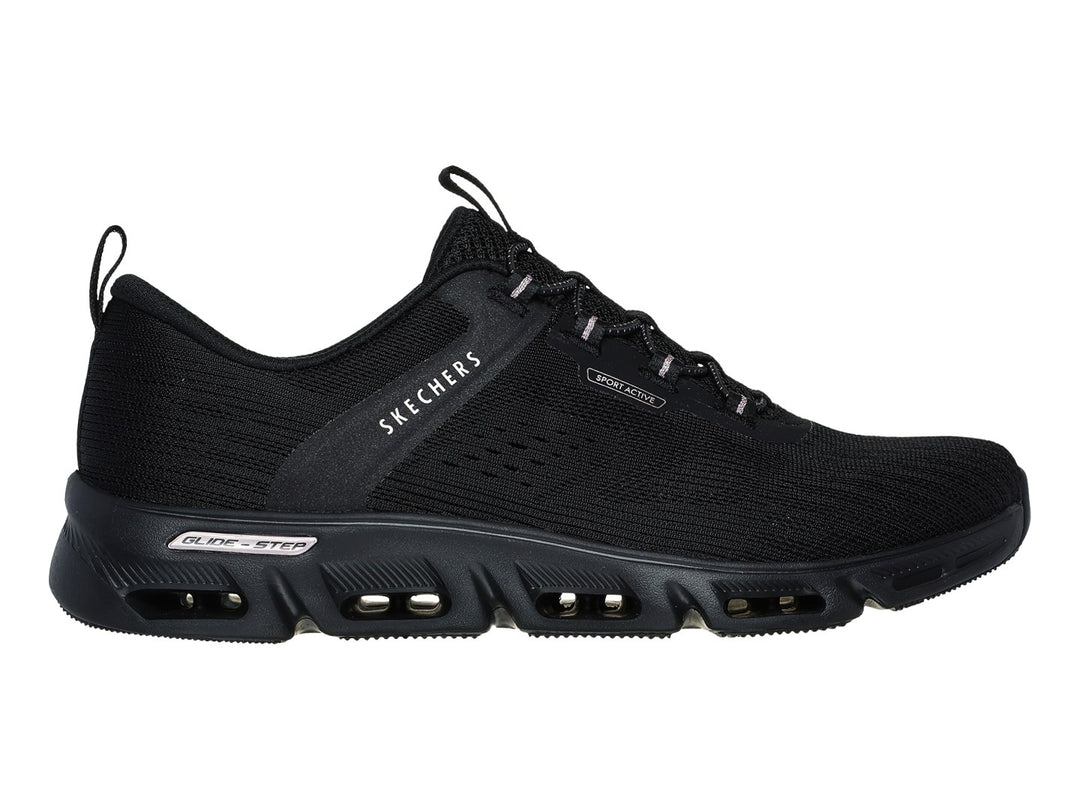 Tenis deportivos Skechers color negro con detalles dorados en la suela y tejido transpirable.