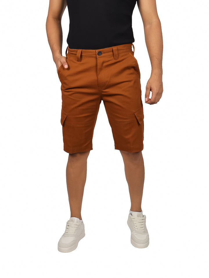 Hombre vistiendo shorts color tabaco con bolsillos laterales tipo cargo y tenis blancos.