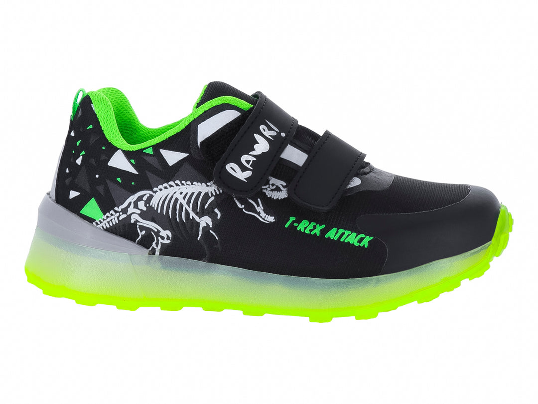 Tenis deportivos infantiles negros con suela verde neón y diseño de esqueleto de dinosaurio.