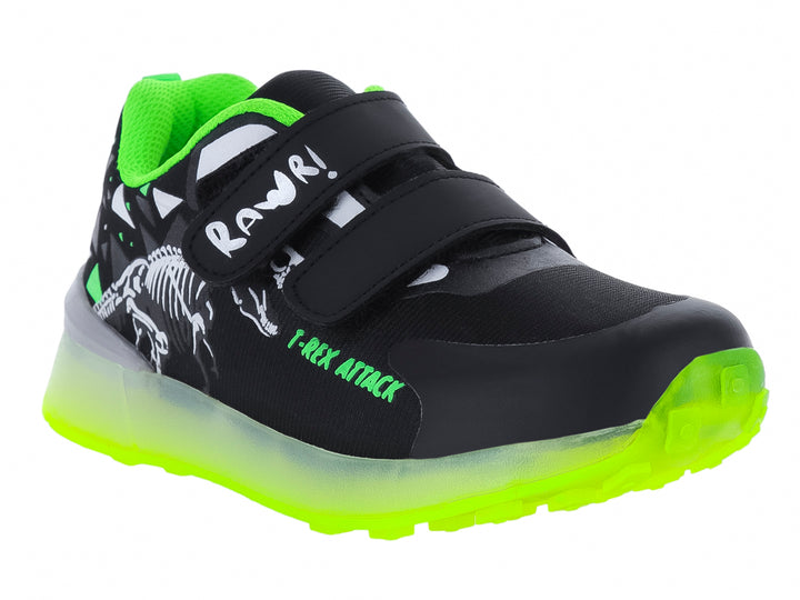 Tenis deportivos infantiles negros con suela verde neón y diseño de esqueleto de dinosaurio.