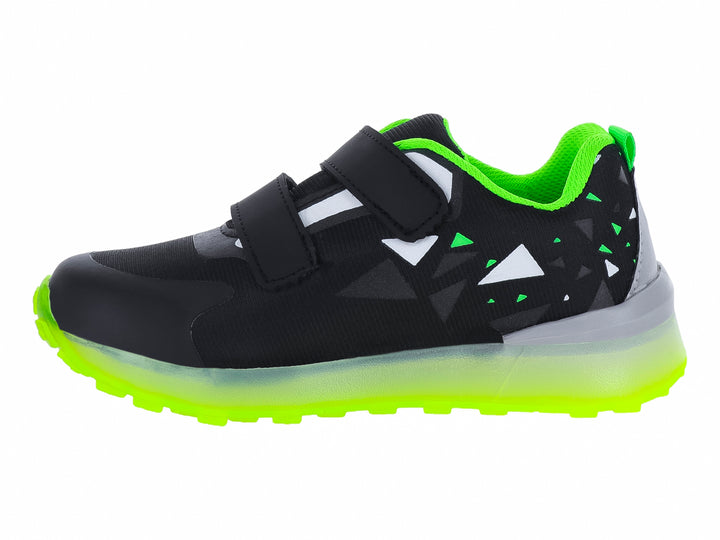 Tenis infantiles negros con suela verde neón y diseño de esqueleto de dinosaurio.