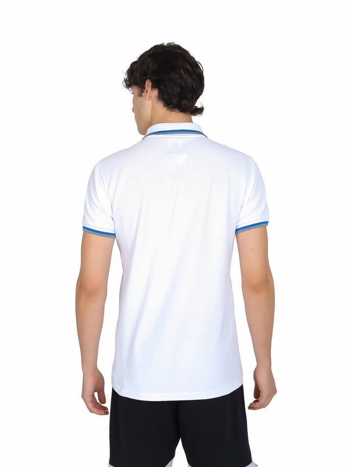 Hombre vistiendo playera polo blanca de manga corta con detalles azules en el cuello y los bordes de las mangas.