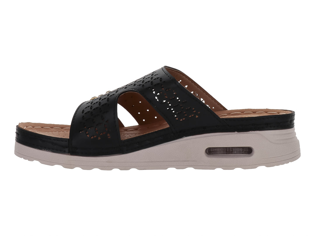Sandalia Flexmas color negro con suela blanca amortiguada y detalles perforados en la parte superior.