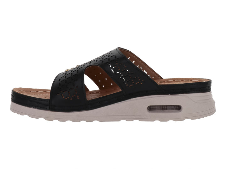 Sandalia Flexmas color negro con suela blanca amortiguada y detalles perforados en la parte superior.